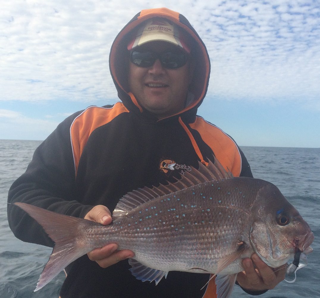 The author with the spoils of jigging the ever-reliable 100mm Swimerz in Mullet colour.