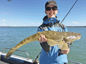 Catherine’s 70cm lizard hit a soft plastic. This will be a capture Catherine remembers for a long time.