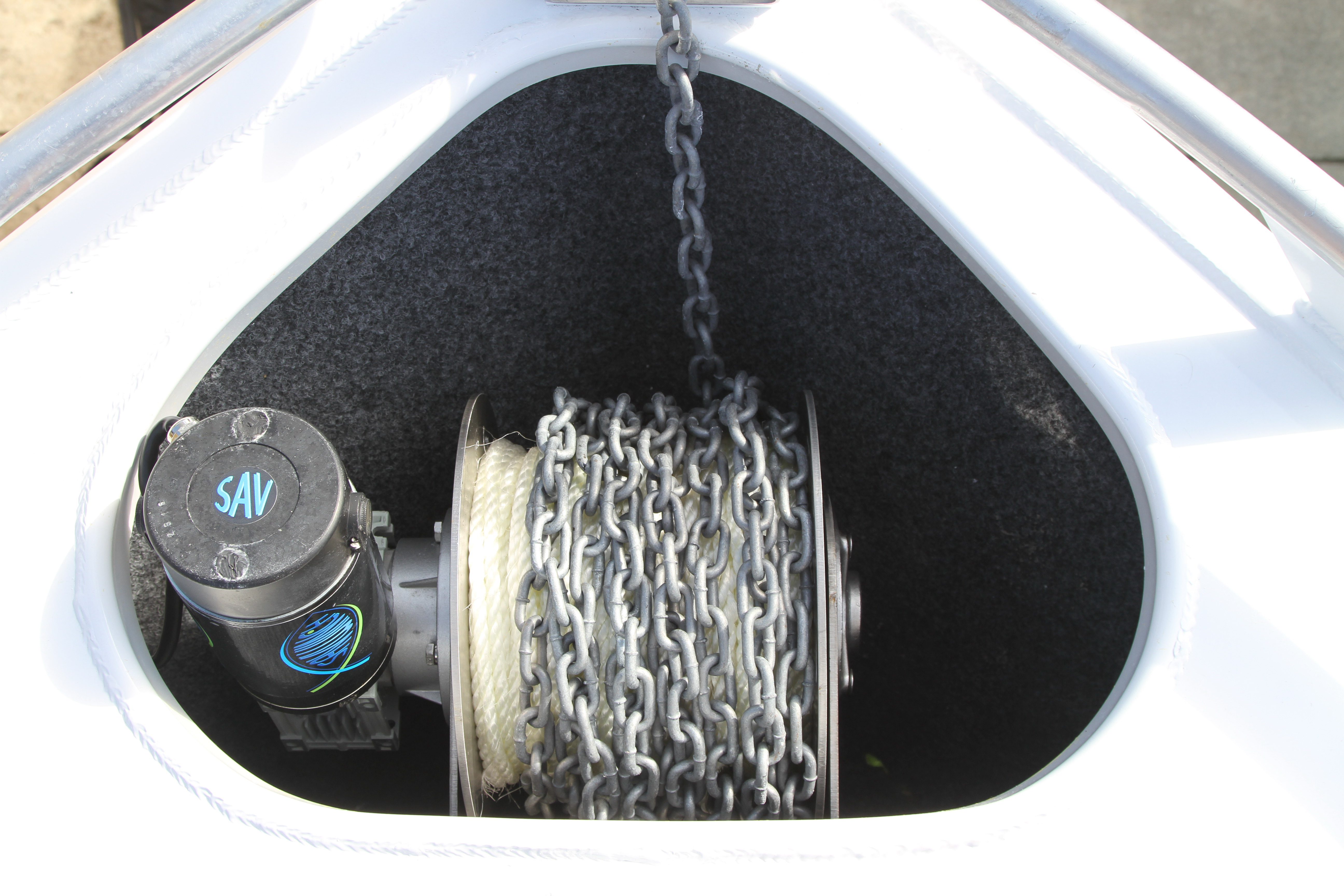 The author's 1500W Savwinch easily fits in the existing anchor well of his boat.