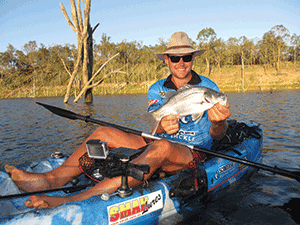 Garry with an afternoon bass caught in the shadows of a rocky outcrop.