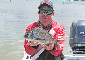 Benno with a bream he hooked first cast on a new Samurai rod. 