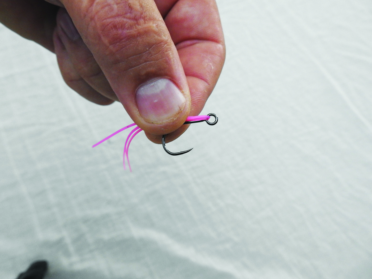Remove the trebles, choose your skirt colour and fit the skirting through the eye of the hook prior to tying a snell knot.