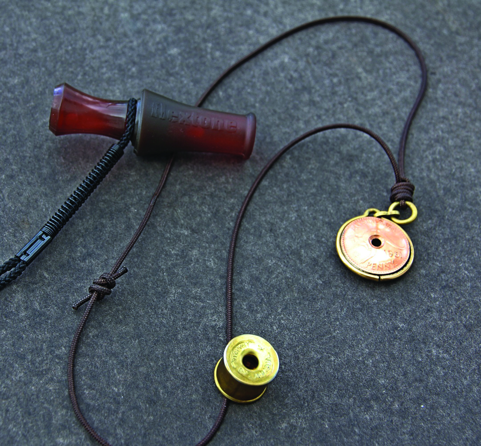 The author’s favourite fox whistles. Closest to the camera is a design made from the brass ends of two 12-gauge shotgun shells. The other metal whistle is of a more traditional shape, but was fashioned from two old Australian pennies. The upper whistle is a Flextone Dying Rabbit call made of rubber and plastic. It doesn't produce the same high-pitched squeak of most fox whistles but does bring them in.