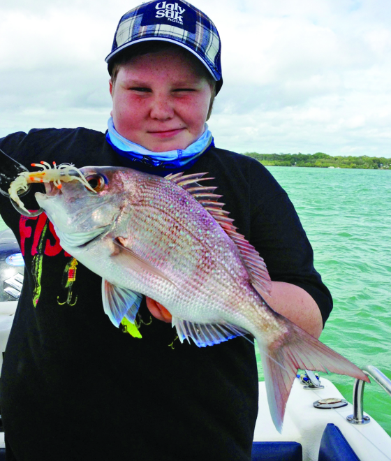 Hayden with a pan size snapper enticed by a Zerek Live Shrimp Hot Legs. 