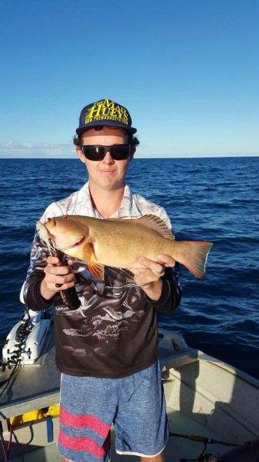 Mitch Beyer with the coral trout he caught while fishing the inshore reefs recently.