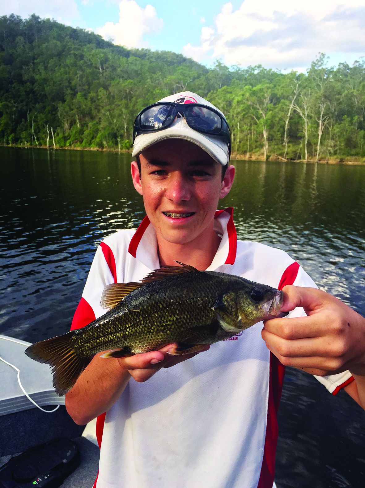 Ryan with a 33cm bass hooked on a brown curly tail from Softplasticsdude.