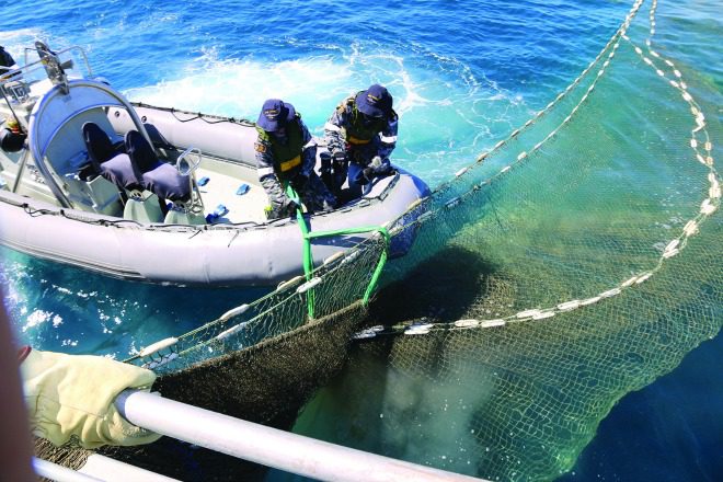 Royal Australian Navy Officers under the command of Maritime Border Command within the Australian Border Force worked for two days to retrieve a ghost net by hand that was almost 2km in length and weighed about five tonnes.