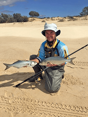 Waders are a must in winter. The author showed off a couple of the average-sized fish turning up on the beaches.