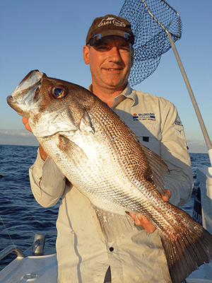 Macca and a 63cm pearl perch hooked 30km from the Wide Bay Bar using light line and a pilchard for bait. 